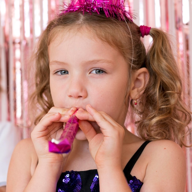 Free photo close-up cute girl with party whistle