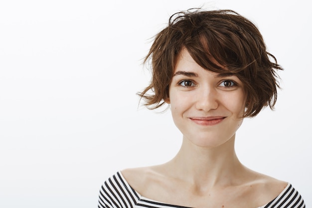 Close-up of cute hipster woman smiling and looking happy