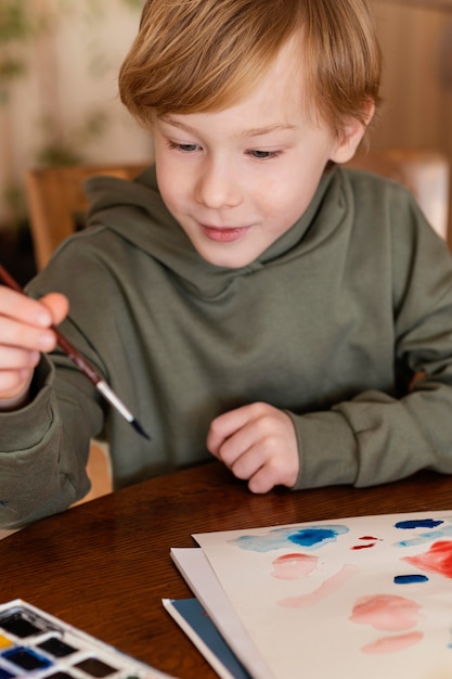 Close-up cute kid looking at brush