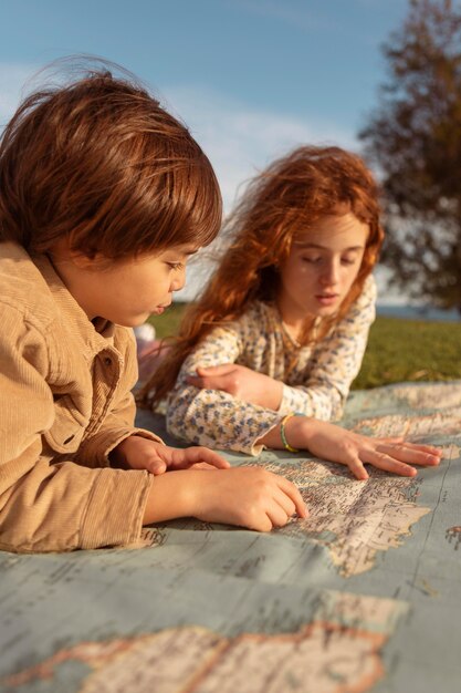 Close-up cute kids looking at map