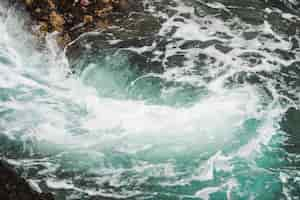 Free photo close-up dark wavy water with whirlpool