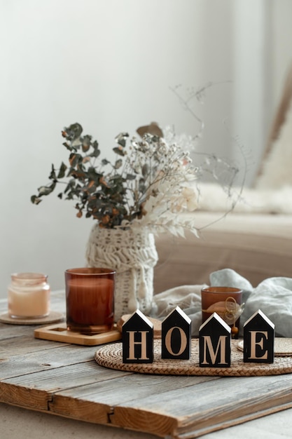 Close up decorative word home on blurred background with candles