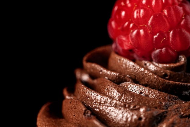 Close-up of delicious chocolate cupcakes with raspberry