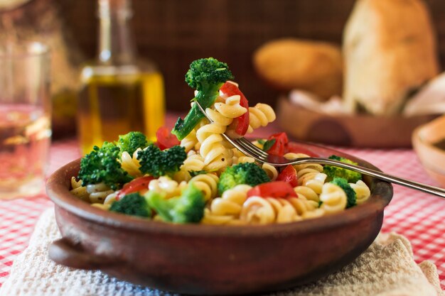 Close-up of delicious fusilli pasta salad with fork