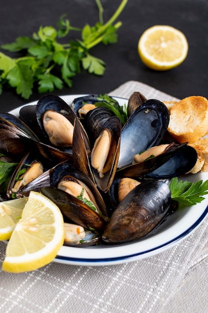 Close-up delicious mussels with lemon slices