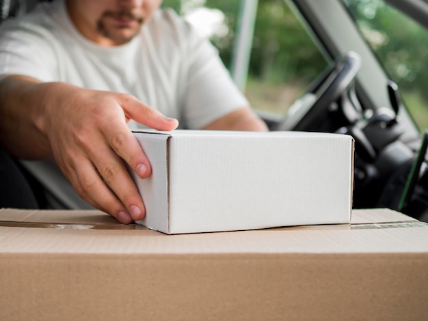 Close-up delivery man in car