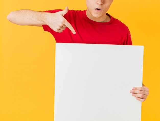 Close-up delivery man pointing at blank paper sheet