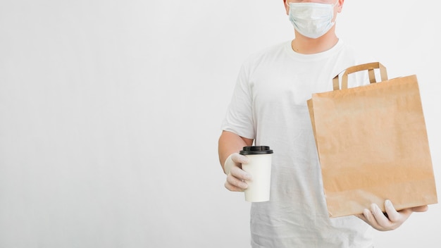 Close-up delivery man wearing mask