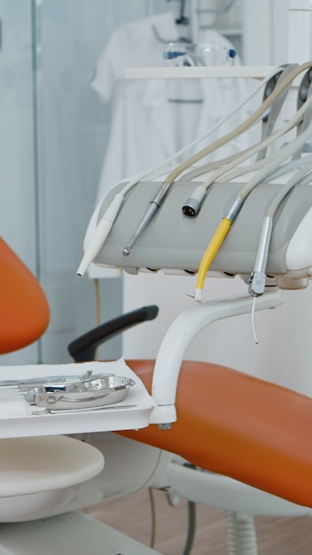 Close up of dental chiar in empty dentist stomatology hospital office with nobody in it