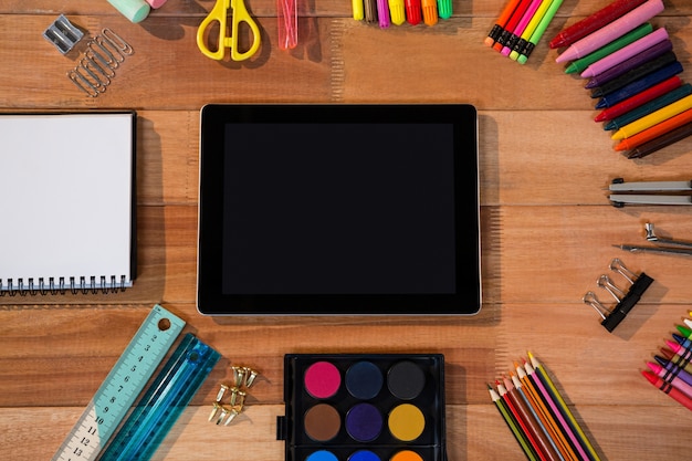 Close-up of digital tablet with various stationery