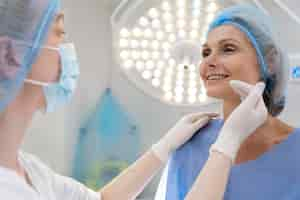 Free photo close up doctor checking smiley patient