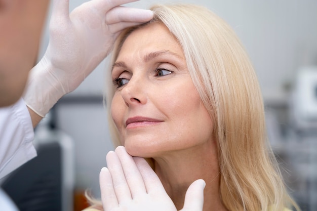 Free photo close up doctor checking woman