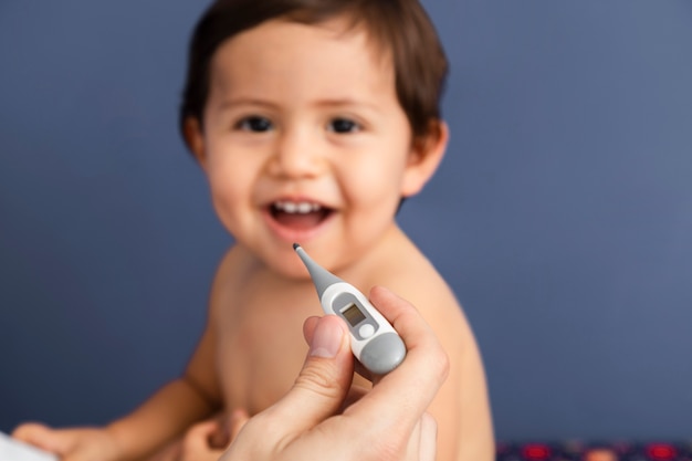 Close-up doctor holding a thermometer