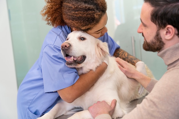 Close up doctor hugging smiley dog