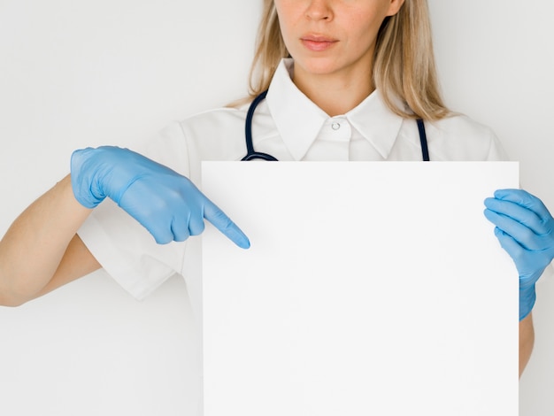 Close-up doctor pointing at paper