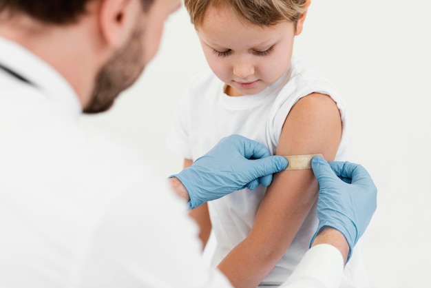 Free photo close-up doctor putting on patch