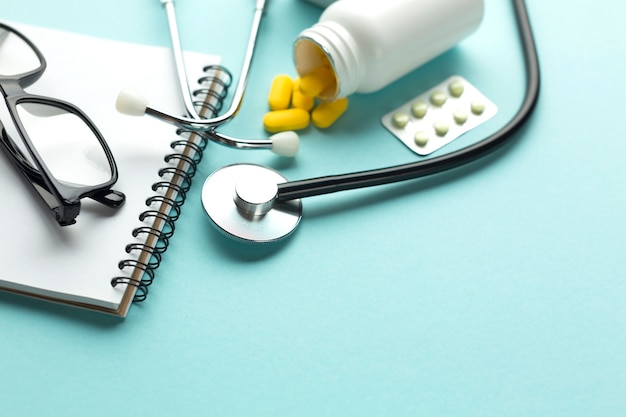 Close-up of a doctor's desk with tablets and spiral notepad