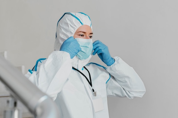 Close-up doctor wearing protective wear