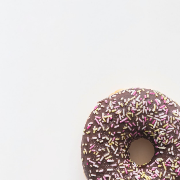 Free photo close-up of donut with sprinkles on white background