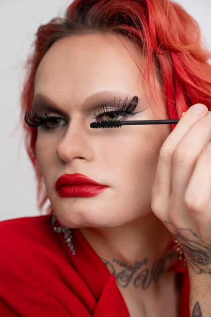 Close up drag putting on mascara