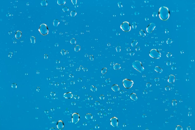 Free photo close-up drops on blue background