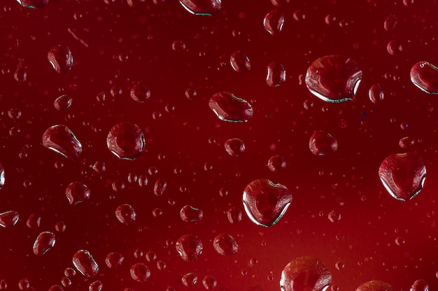 Close-up drops on red background