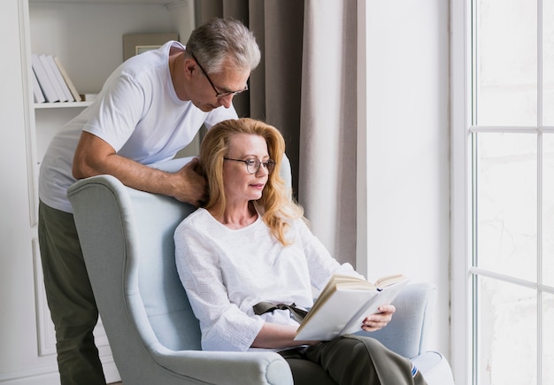 Free photo close-up elderly couple reading a book