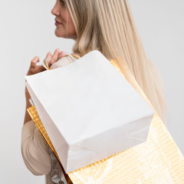 Free Photo close-up elegant woman carrying shopping bags