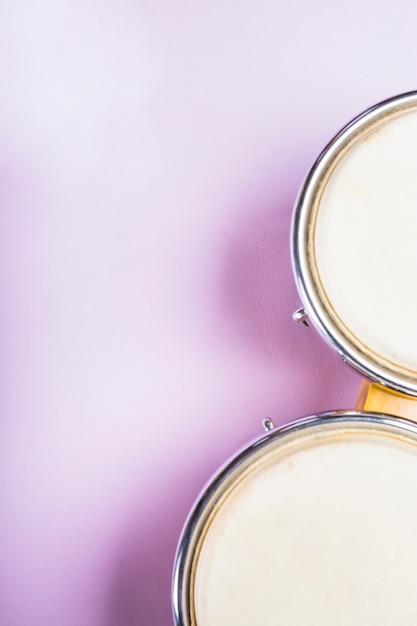 Close-up of an elevated view of bongo drum on purple background