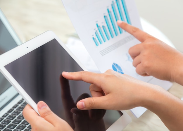 Free Photo close-up of employee pointing at tablet