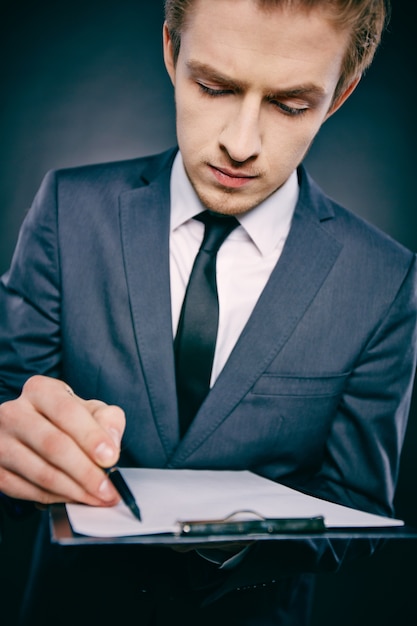 Free photo close-up of executive filling out a report