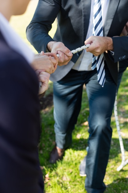 Free Photo close-up of executive with suit playing tug of war