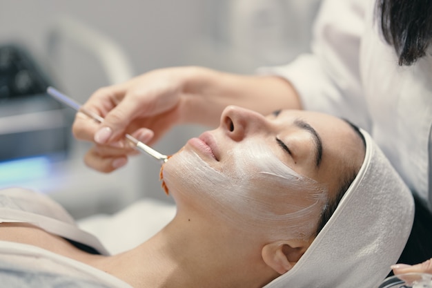 Close-up of the face of a young woman relaxing under the gentle