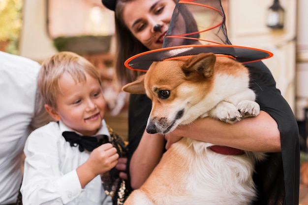 Free Photo close-up family holding cute dog