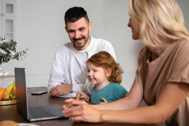 Close up family at home with laptop