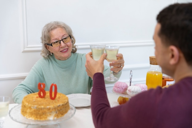 Free Photo close up family members clinking glasses