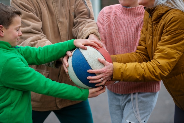 Free Photo close up family members holding ball