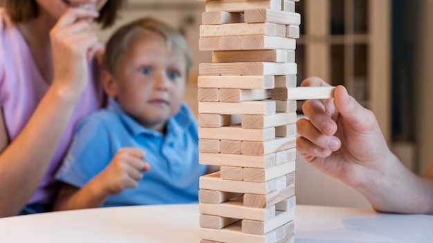 Close-up family playing jenga together