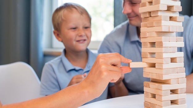 Close-up family playing jenga together