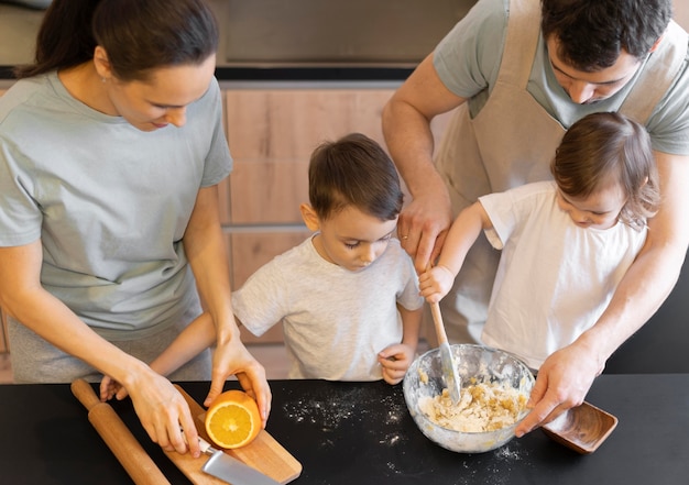 Free Photo close-up family preparing desert