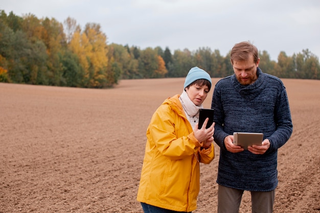 Free Photo close up on farmer using digital device