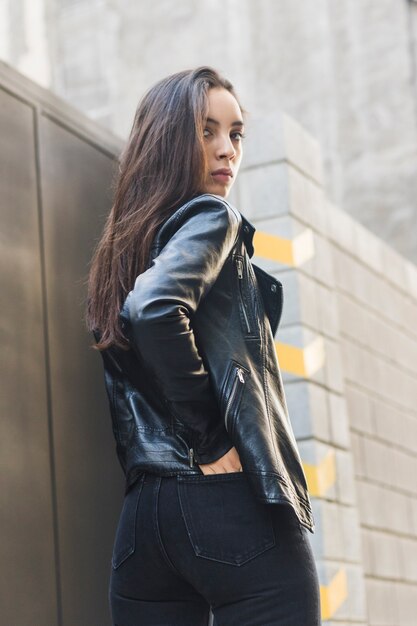 Close-up of a fashionable young woman with her hand in back jeans pocket