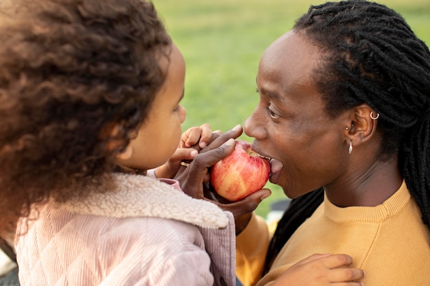 Close up father eating apple