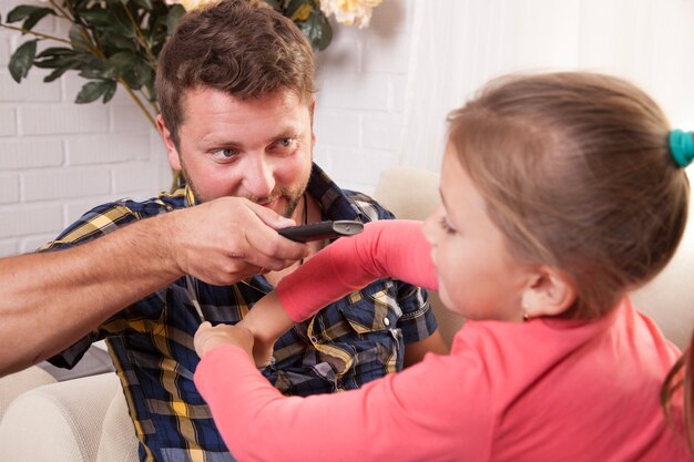 Close-up of father playing with the remote control