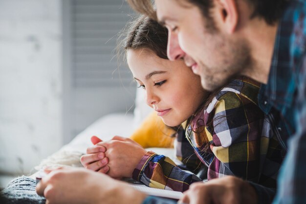 Close up fathers day concept with father and daughter reading