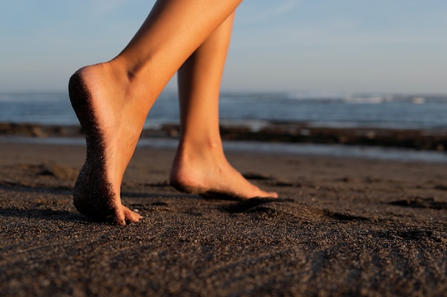 Close-up. feet on black sand. bali