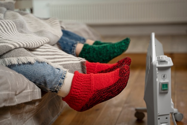 Free Photo close up feet getting warm near heater