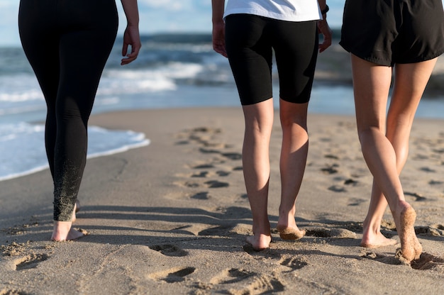 Close-up feet walking on shore