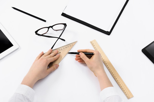 Free photo close-up of female architect drawing the sketches on white paper