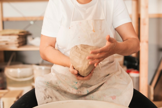 Free Photo close-up of female craftsman kneading the dough